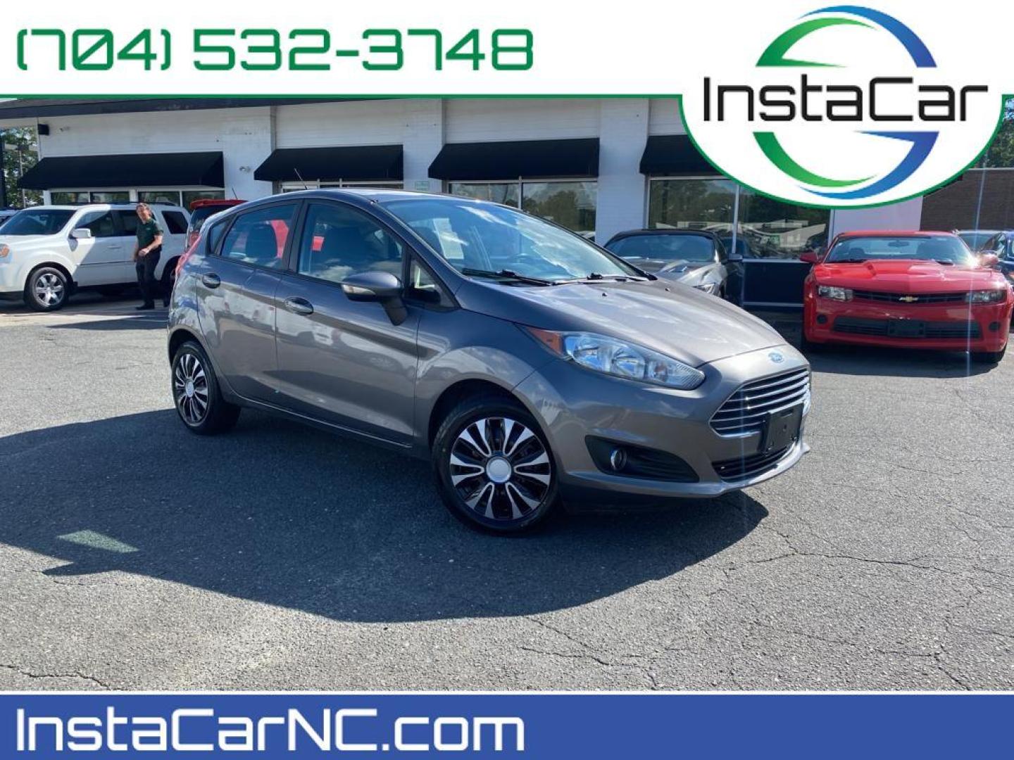 2014 Storm Gray Metallic /Charcoal Black w/Red Stitching Ford Fiesta SE (3FADP4EJ9EM) with an L4, 1.6L engine, 5-speed manual transmission, located at 3147 E Independence Blvd, Charlotte, NC, 28205, 35.200268, -80.773651 - <b>Equipment</b><br>This 2014 Ford Fiesta features a hands-free Bluetooth phone system. This vehicle is a certified CARFAX 1-owner. This vehicle has a L4, 1.6L high output engine. Front wheel drive on this 2014 Ford Fiesta gives you better traction and better fuel economy. Set the temperature exac - Photo#0