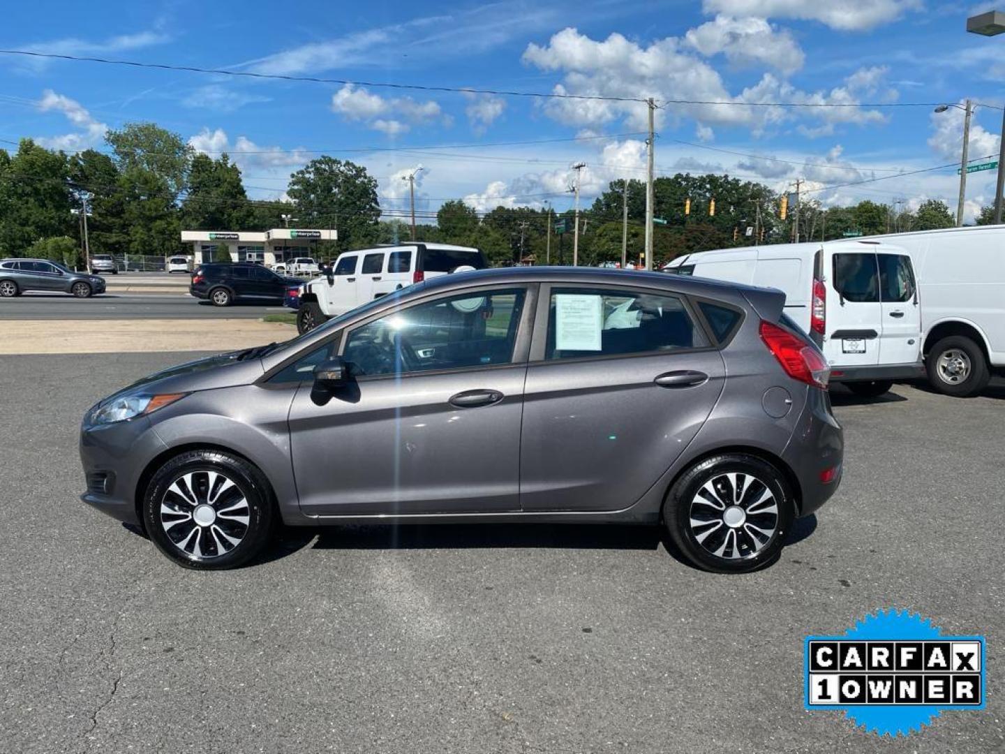 2014 Storm Gray Metallic /Charcoal Black w/Red Stitching Ford Fiesta SE (3FADP4EJ9EM) with an L4, 1.6L engine, 5-speed manual transmission, located at 3147 E Independence Blvd, Charlotte, NC, 28205, 35.200268, -80.773651 - <b>Equipment</b><br>This 2014 Ford Fiesta features a hands-free Bluetooth phone system. This vehicle is a certified CARFAX 1-owner. This vehicle has a L4, 1.6L high output engine. Front wheel drive on this 2014 Ford Fiesta gives you better traction and better fuel economy. Set the temperature exac - Photo#9