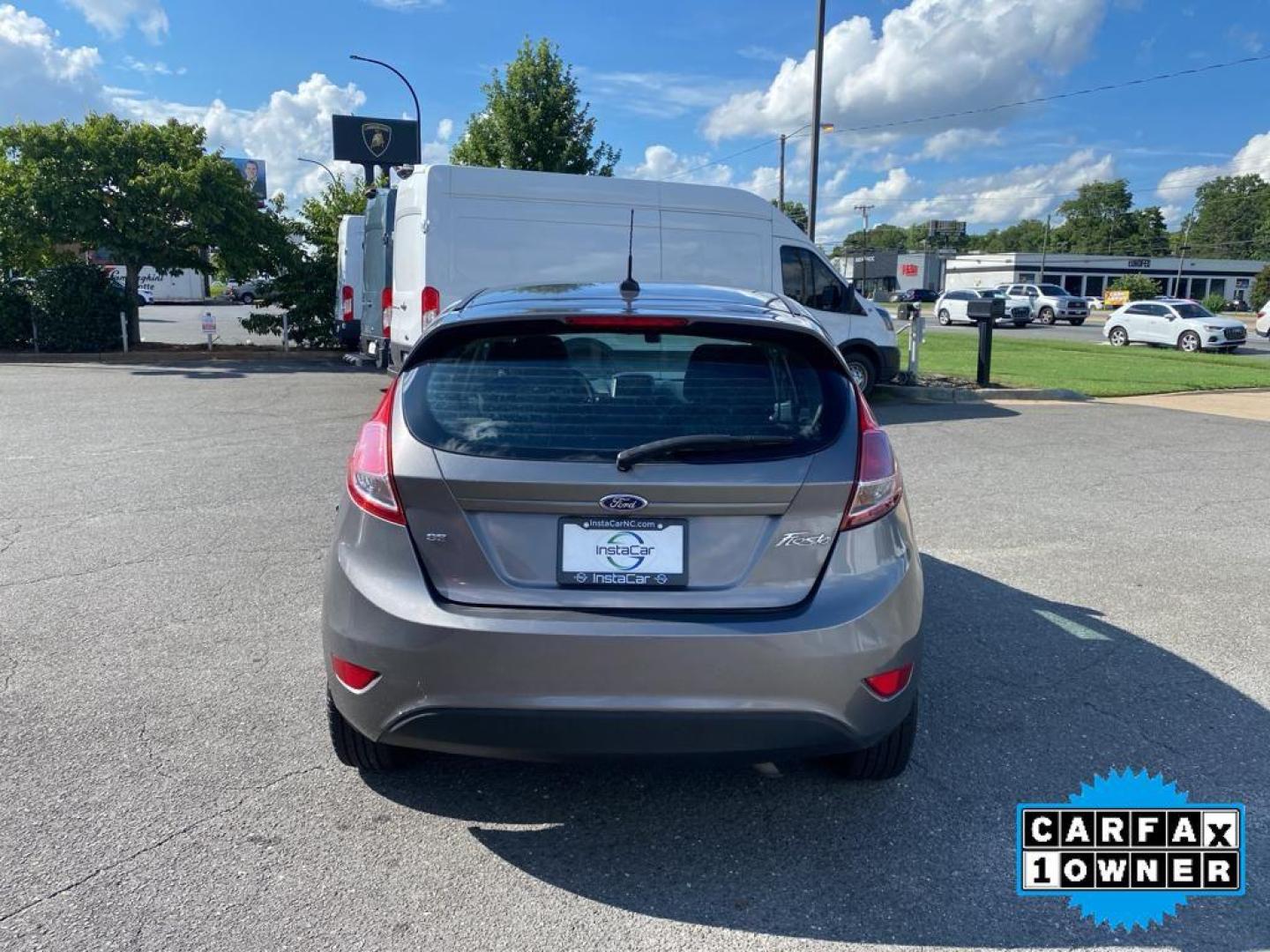 2014 Storm Gray Metallic /Charcoal Black w/Red Stitching Ford Fiesta SE (3FADP4EJ9EM) with an L4, 1.6L engine, 5-speed manual transmission, located at 3147 E Independence Blvd, Charlotte, NC, 28205, 35.200268, -80.773651 - <b>Equipment</b><br>This 2014 Ford Fiesta features a hands-free Bluetooth phone system. This vehicle is a certified CARFAX 1-owner. This vehicle has a L4, 1.6L high output engine. Front wheel drive on this 2014 Ford Fiesta gives you better traction and better fuel economy. Set the temperature exac - Photo#11