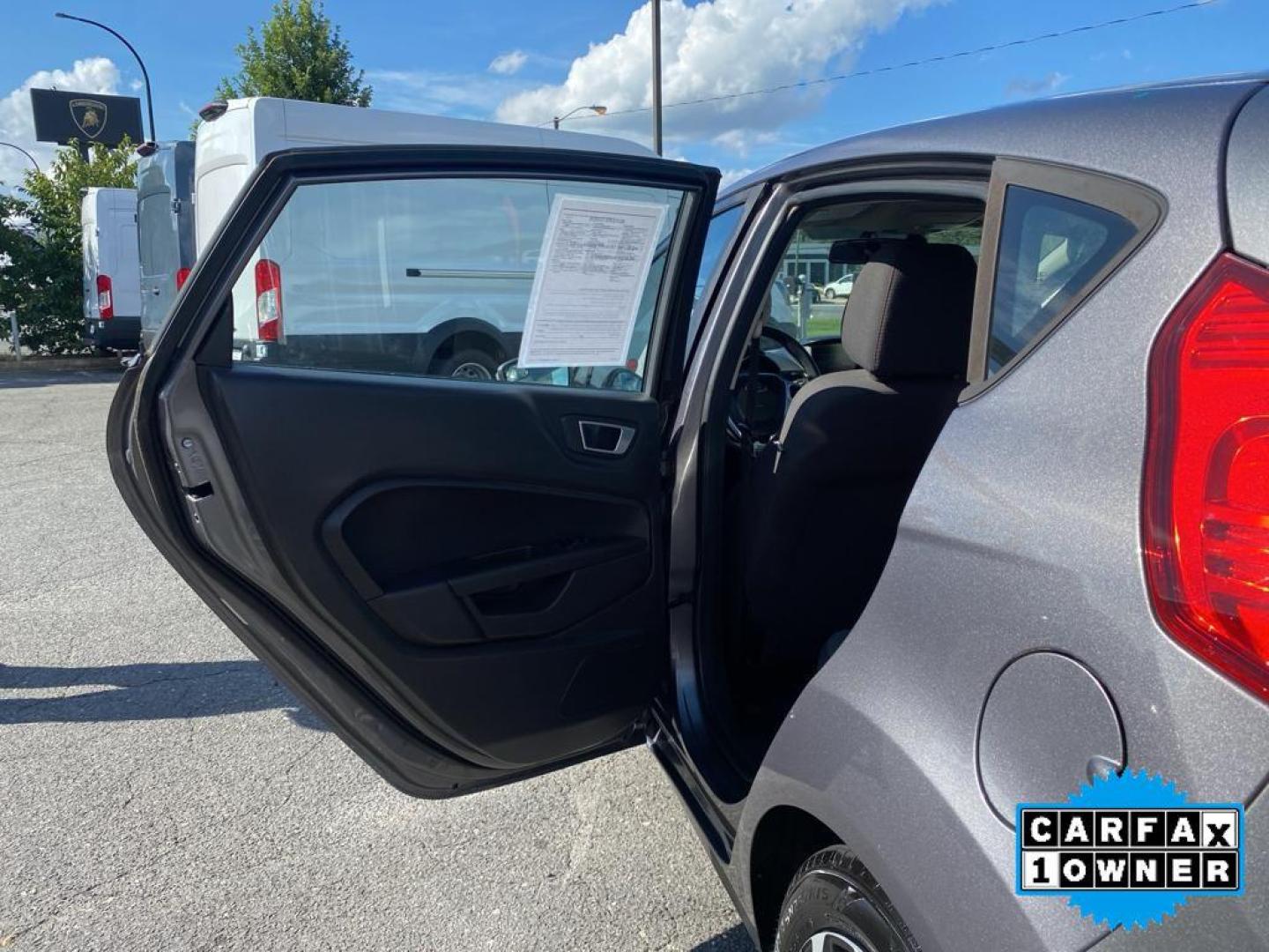 2014 Storm Gray Metallic /Charcoal Black w/Red Stitching Ford Fiesta SE (3FADP4EJ9EM) with an L4, 1.6L engine, 5-speed manual transmission, located at 3147 E Independence Blvd, Charlotte, NC, 28205, 35.200268, -80.773651 - <b>Equipment</b><br>This 2014 Ford Fiesta features a hands-free Bluetooth phone system. This vehicle is a certified CARFAX 1-owner. This vehicle has a L4, 1.6L high output engine. Front wheel drive on this 2014 Ford Fiesta gives you better traction and better fuel economy. Set the temperature exac - Photo#20