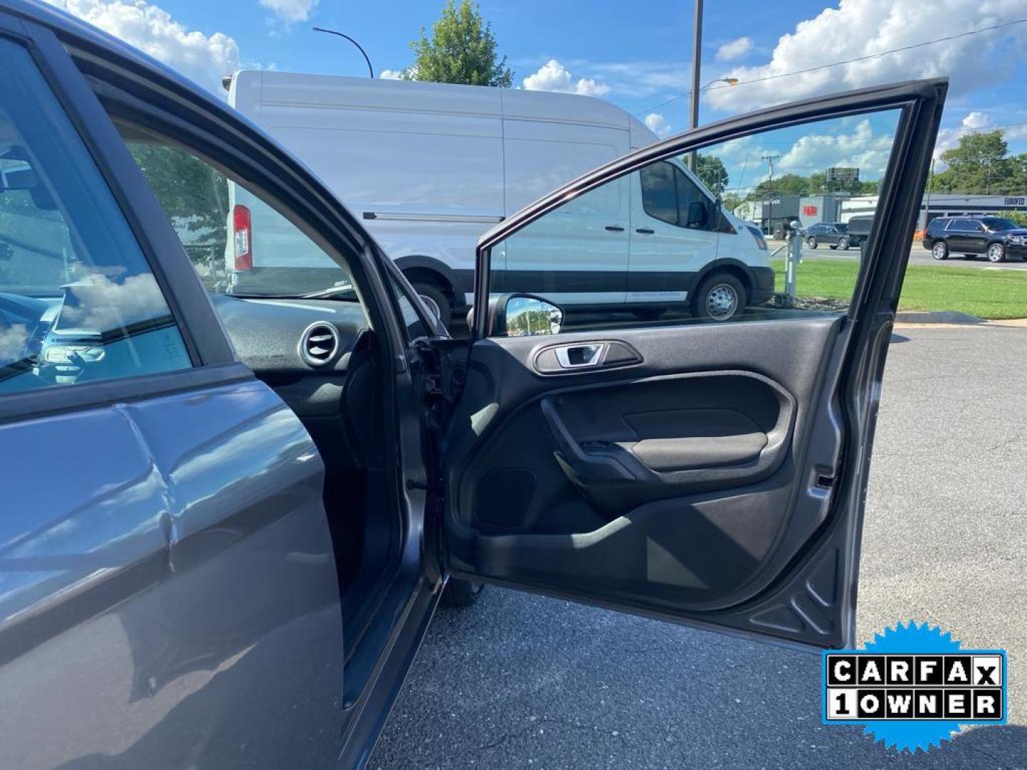 2014 Storm Gray Metallic /Charcoal Black w/Red Stitching Ford Fiesta SE (3FADP4EJ9EM) with an L4, 1.6L engine, 5-speed manual transmission, located at 3147 E Independence Blvd, Charlotte, NC, 28205, 35.200268, -80.773651 - <b>Equipment</b><br>This 2014 Ford Fiesta features a hands-free Bluetooth phone system. This vehicle is a certified CARFAX 1-owner. This vehicle has a L4, 1.6L high output engine. Front wheel drive on this 2014 Ford Fiesta gives you better traction and better fuel economy. Set the temperature exac - Photo#22