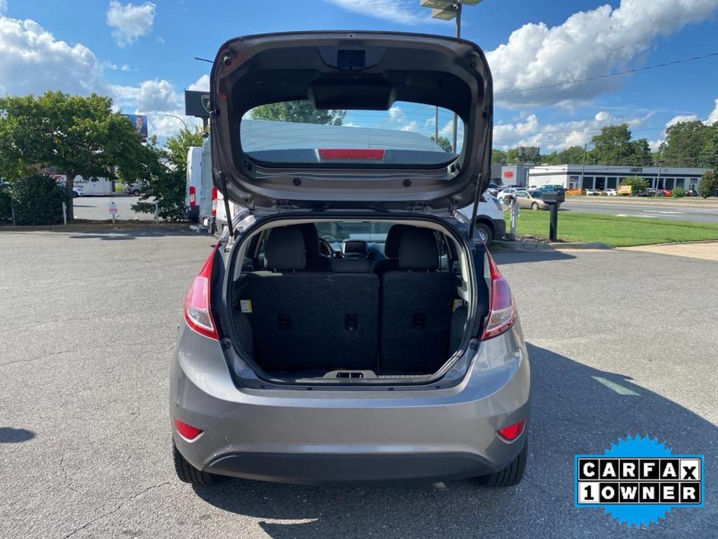 2014 Storm Gray Metallic /Charcoal Black w/Red Stitching Ford Fiesta SE (3FADP4EJ9EM) with an L4, 1.6L engine, 5-speed manual transmission, located at 3147 E Independence Blvd, Charlotte, NC, 28205, 35.200268, -80.773651 - <b>Equipment</b><br>This 2014 Ford Fiesta features a hands-free Bluetooth phone system. This vehicle is a certified CARFAX 1-owner. This vehicle has a L4, 1.6L high output engine. Front wheel drive on this 2014 Ford Fiesta gives you better traction and better fuel economy. Set the temperature exac - Photo#29