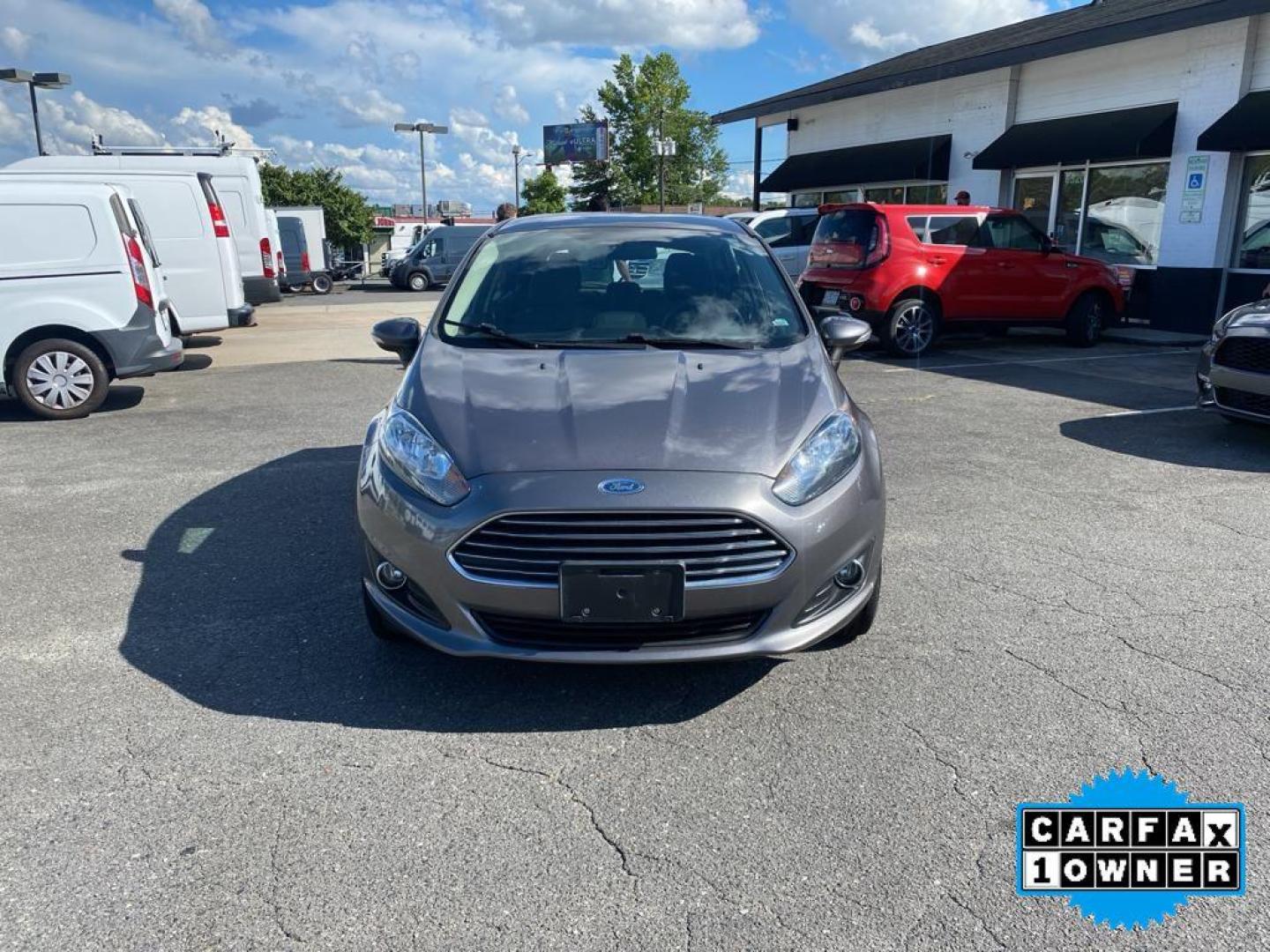 2014 Storm Gray Metallic /Charcoal Black w/Red Stitching Ford Fiesta SE (3FADP4EJ9EM) with an L4, 1.6L engine, 5-speed manual transmission, located at 3147 E Independence Blvd, Charlotte, NC, 28205, 35.200268, -80.773651 - <b>Equipment</b><br>This 2014 Ford Fiesta features a hands-free Bluetooth phone system. This vehicle is a certified CARFAX 1-owner. This vehicle has a L4, 1.6L high output engine. Front wheel drive on this 2014 Ford Fiesta gives you better traction and better fuel economy. Set the temperature exac - Photo#7