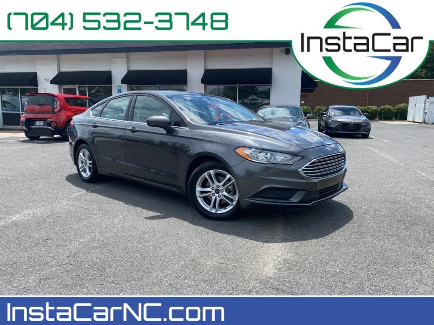 2018 Magnetic Metallic /Ebony Ford Fusion SE (3FA6P0H75JR) with an L4, 2.5L engine, 6-speed automatic transmission, located at 3147 E Independence Blvd, Charlotte, NC, 28205, 35.200268, -80.773651 - <b>Equipment</b><br>It is equipped with the latest generation of XM/Sirius Radio. Protect this 2018 Ford Fusion from unwanted accidents with a cutting edge backup camera system. This Ford Fusion features a hands-free Bluetooth phone system. The Ford Fusion has satellite radio capabilities. Set the - Photo#0