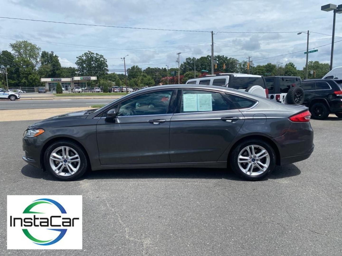 2018 Magnetic Metallic /Ebony Ford Fusion SE (3FA6P0H75JR) with an L4, 2.5L engine, 6-speed automatic transmission, located at 3147 E Independence Blvd, Charlotte, NC, 28205, 35.200268, -80.773651 - <b>Equipment</b><br>It is equipped with the latest generation of XM/Sirius Radio. Protect this 2018 Ford Fusion from unwanted accidents with a cutting edge backup camera system. This Ford Fusion features a hands-free Bluetooth phone system. The Ford Fusion has satellite radio capabilities. Set the - Photo#10