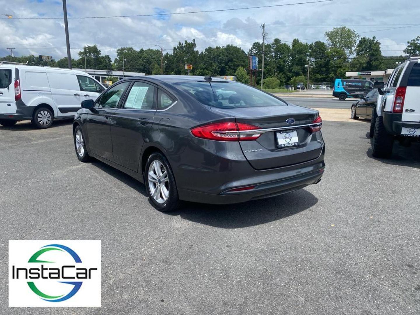 2018 Magnetic Metallic /Ebony Ford Fusion SE (3FA6P0H75JR) with an L4, 2.5L engine, 6-speed automatic transmission, located at 3147 E Independence Blvd, Charlotte, NC, 28205, 35.200268, -80.773651 - <b>Equipment</b><br>It is equipped with the latest generation of XM/Sirius Radio. Protect this 2018 Ford Fusion from unwanted accidents with a cutting edge backup camera system. This Ford Fusion features a hands-free Bluetooth phone system. The Ford Fusion has satellite radio capabilities. Set the - Photo#11