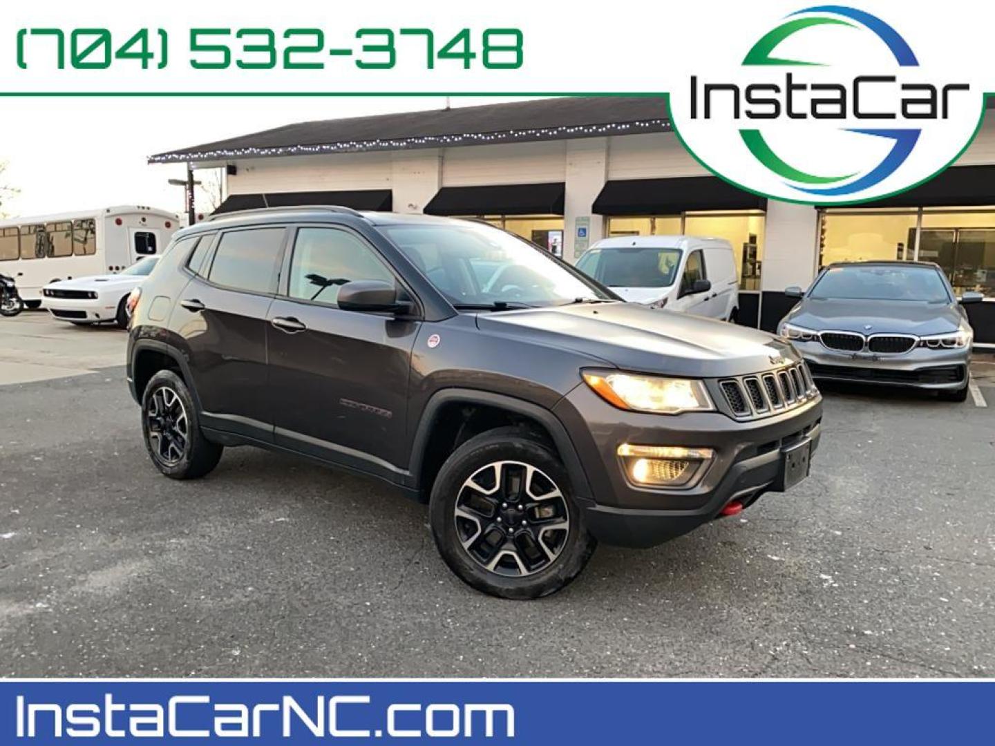 2021 Granite Crystal Metallic Clearcoat /Ruby Red/Black Jeep Compass Trailhawk (3C4NJDDB6MT) with an 4 Cyl, 2.4L engine, 9-speed automatic transmission, located at 3147 E Independence Blvd, Charlotte, NC, 28205, 35.200268, -80.773651 - <b>Equipment</b><br>The leather seats in it are a must for buyers looking for comfort, durability, and style. It's Forward Collision Warning feature alerts drivers to potential front-end collisions. The vehicle's Lane Departure Warning keeps you safe by alerting you when you drift from your lane. Th - Photo#0